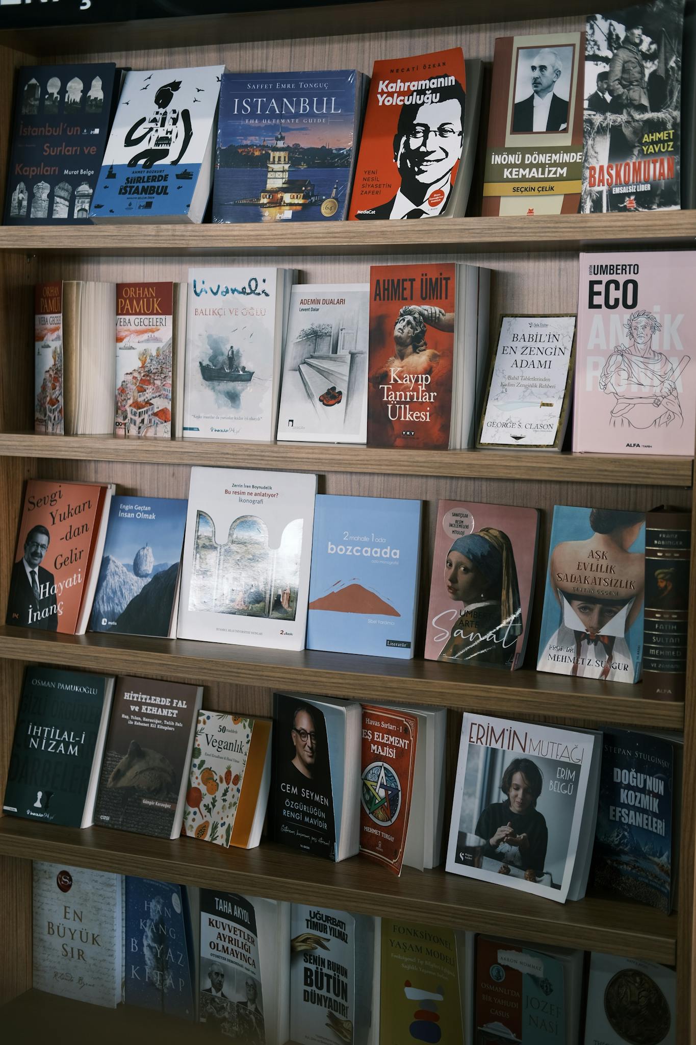 Colorful selection of Turkish books on shelves in an Istanbul library setting.